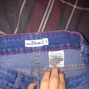 Light blue jeans with rips and pockets on the leg sides